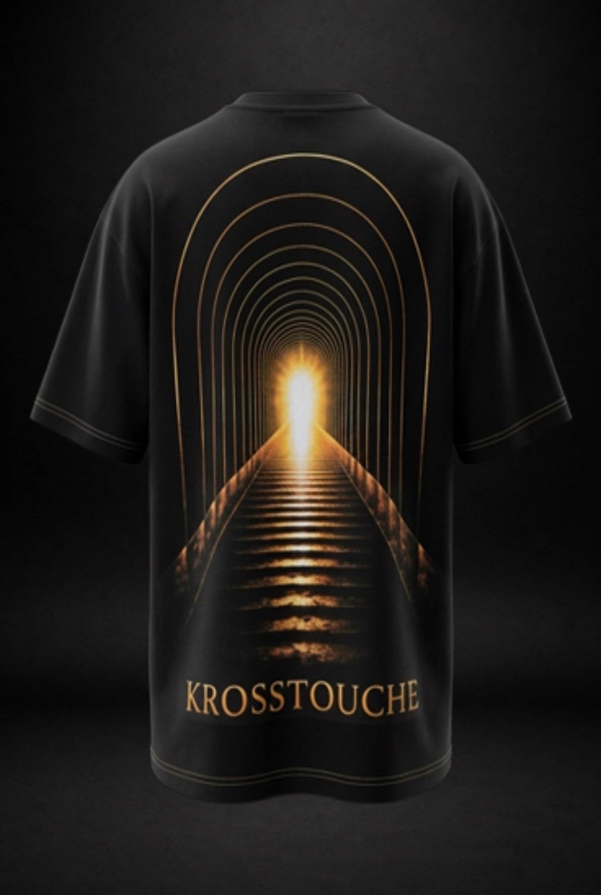 Back view of a black KROSSTOUCHE® T-shirt featuring a striking golden illuminated staircase tunnel graphic, symbolising a journey towards light, with KROSSTOUCHE® lettering near the bottom and gold double-stitched sleeve and hem details.