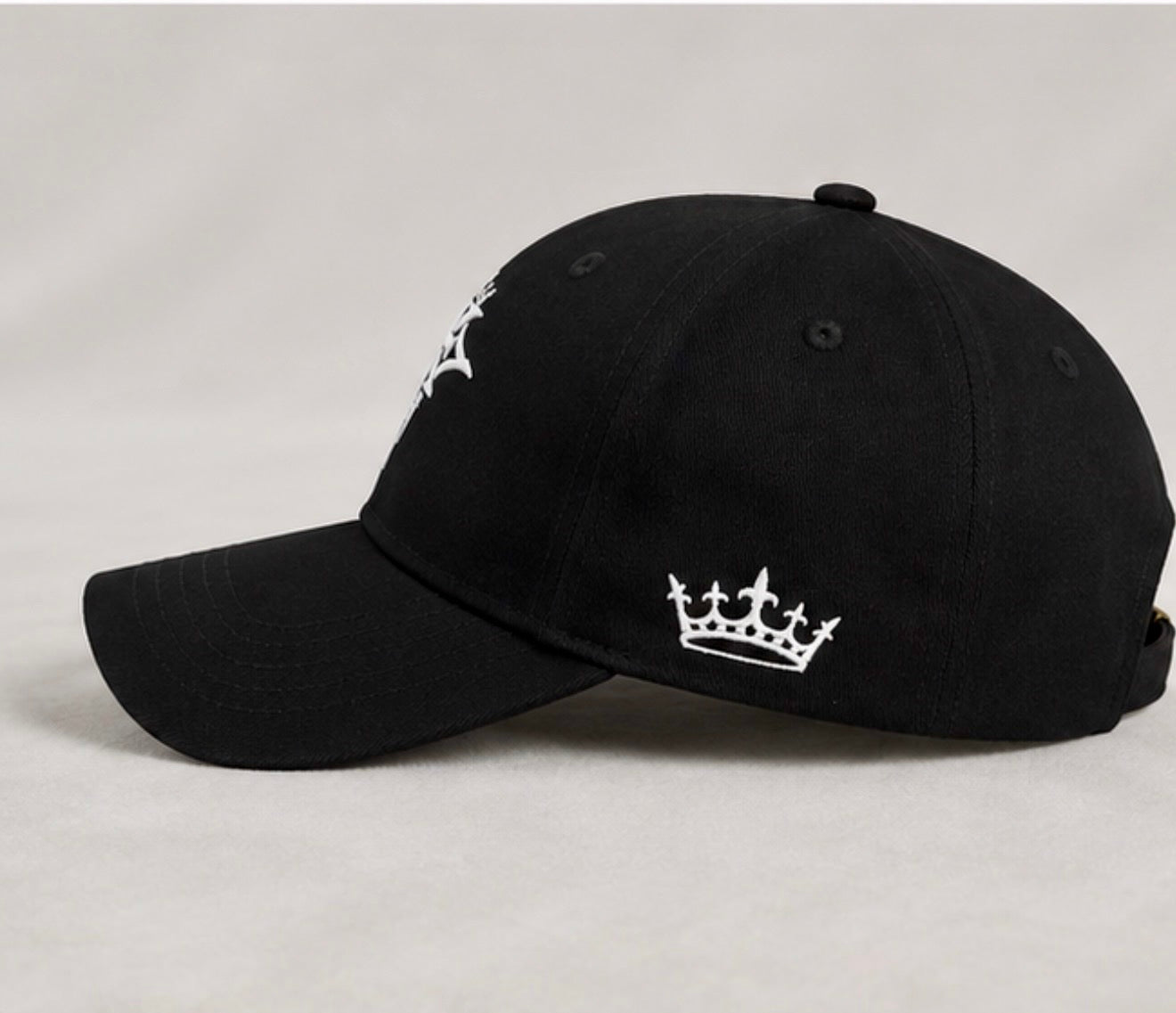 Left side view of the KROSSTOUCHE® Signature Black Baseball Cap featuring the embroidered crown logo.