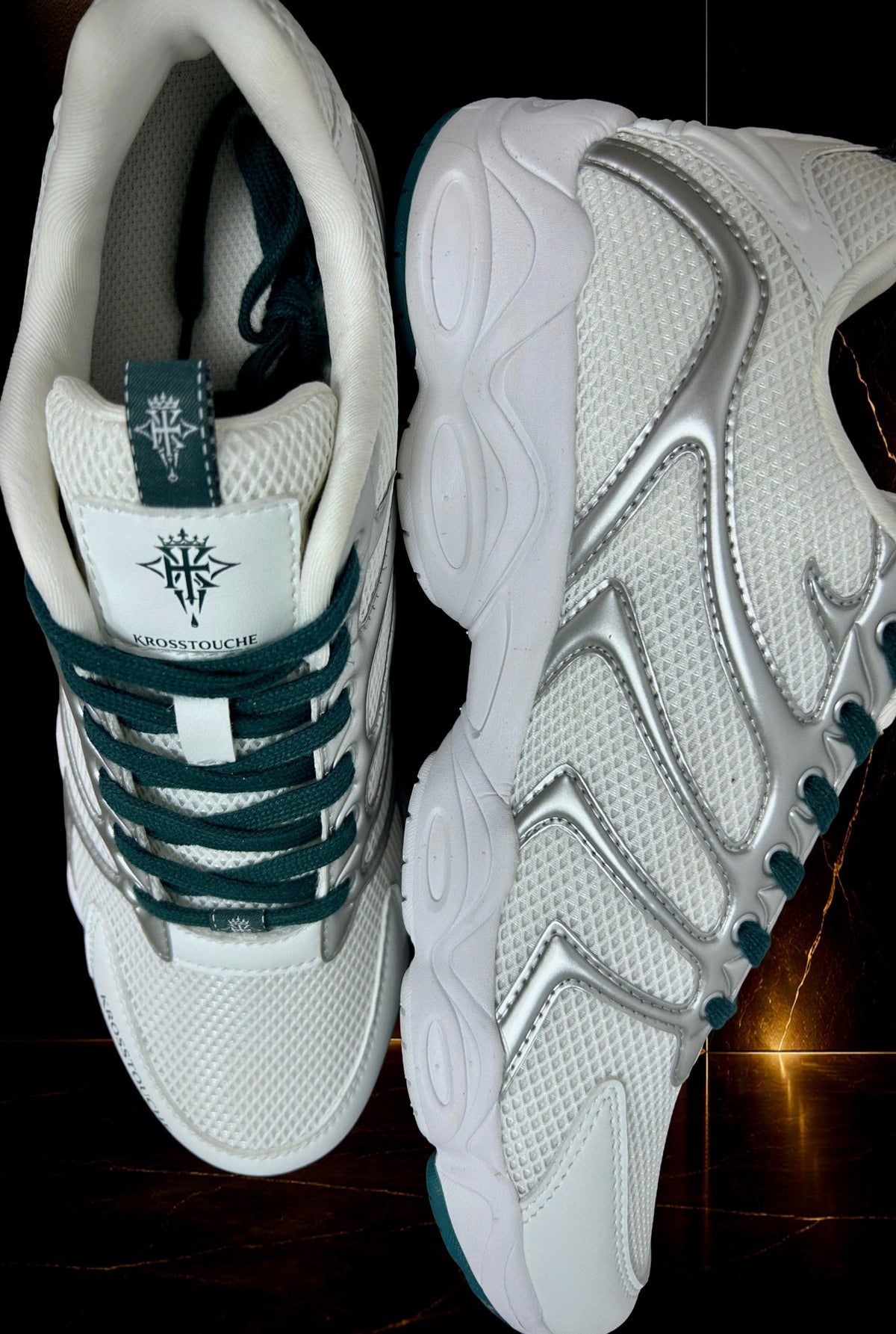 KROSSTOUCHE® CROWN RUNNER 01 luxury sneaker in white, silver and deep emerald green, showing the front, side profile, signature crown emblem and sculpted sole