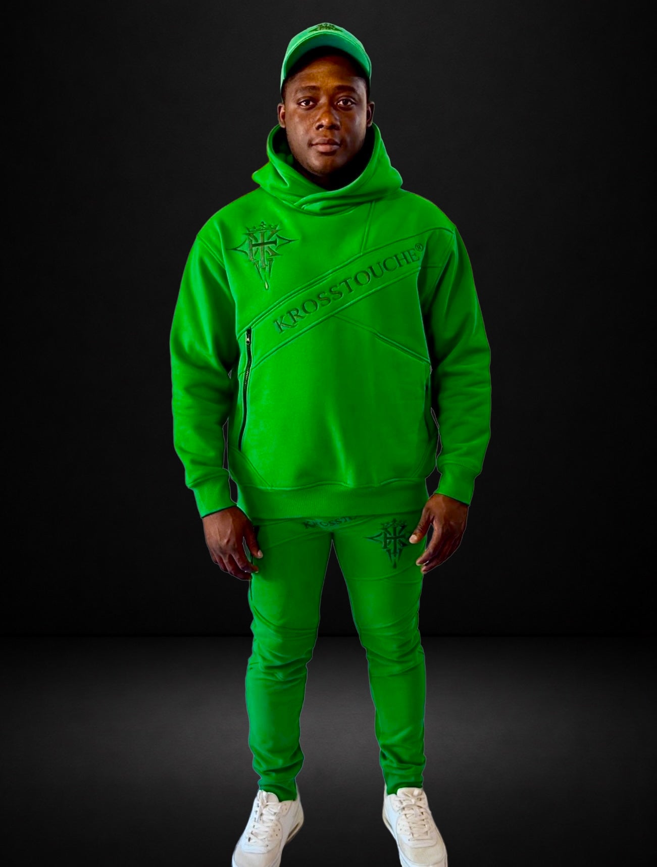 Male model wearing the KROSSTOUCHE® Emerald Signature Joggers with the matching green hoodie and cap, front view.
