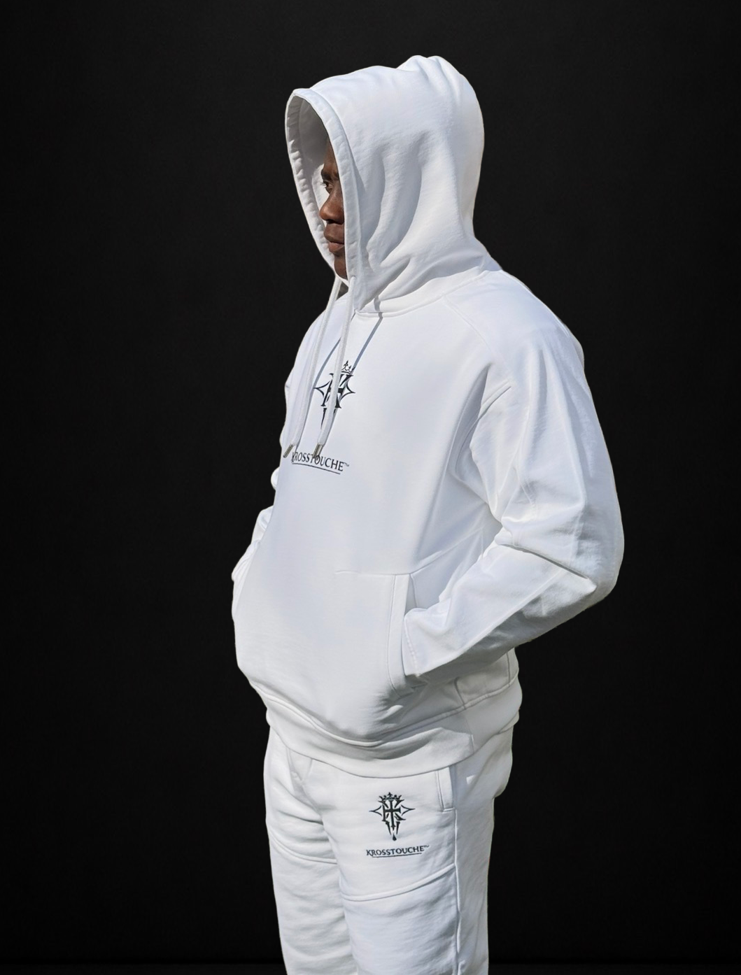 Side profile of a model wearing the KROSSTOUCHE® Providence hoodie and panelled joggers in optic white