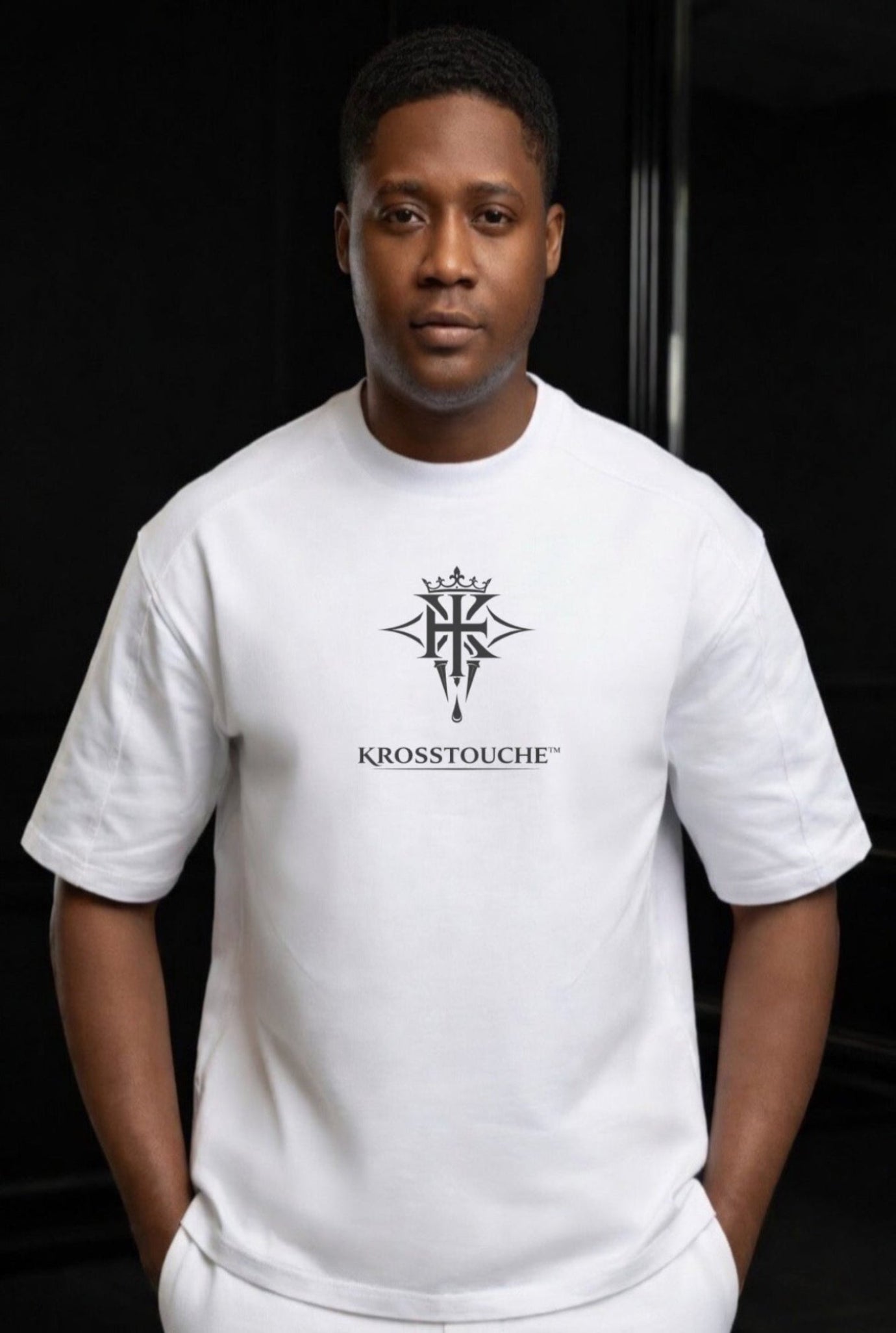 KROSSTOUCHE® white luxury t-shirt with signature logo worn by model on a black background